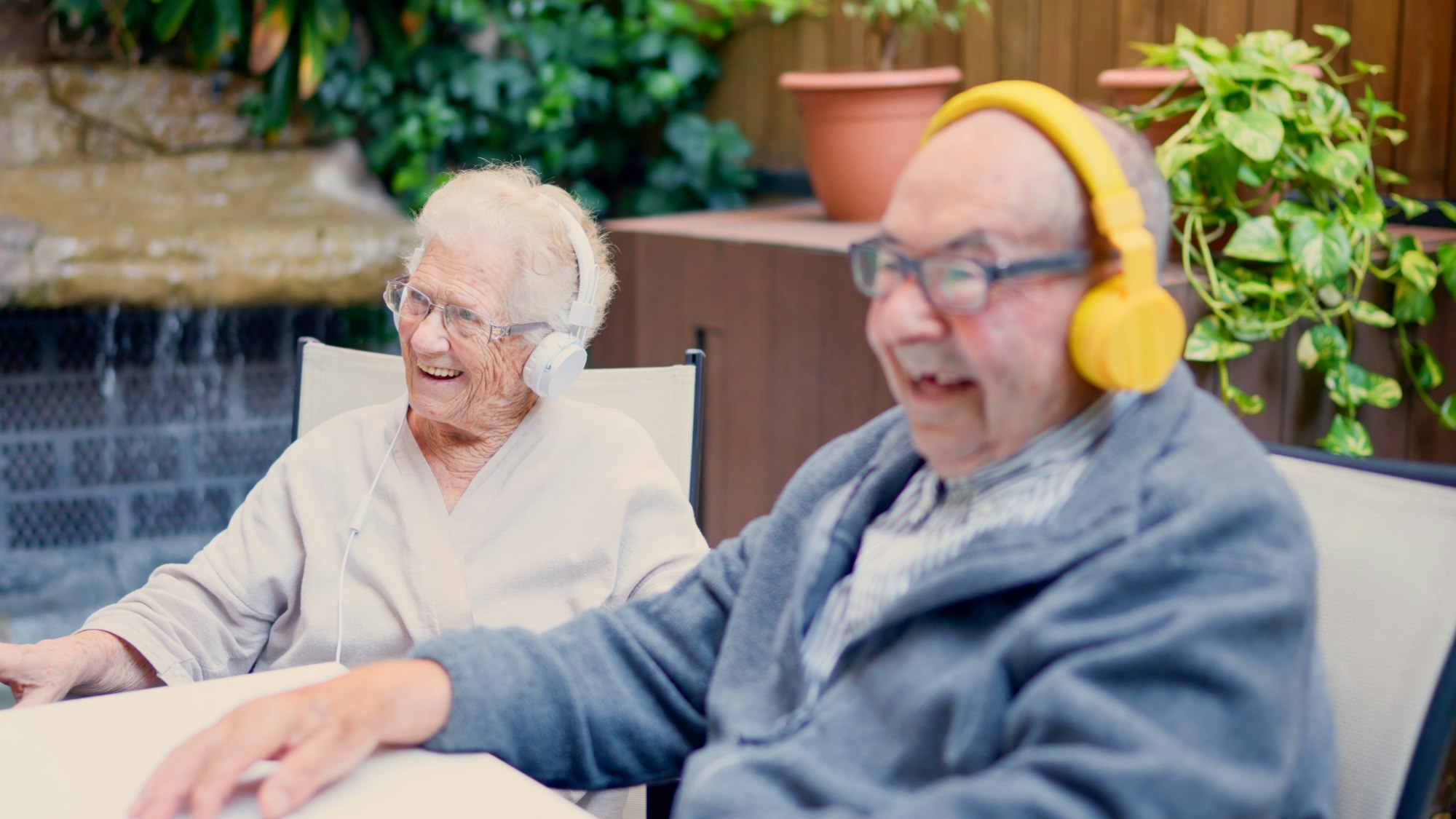 Senior couple listening to music on the garden of geriatric